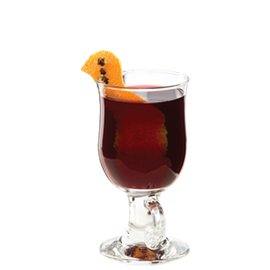 Irish coffee glass with dark red drink orange peel with cloves plain background