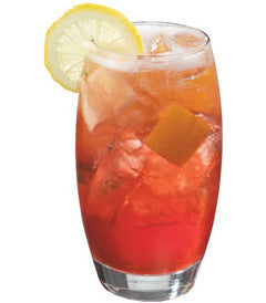 Highball glass with orange red drink lemon wheel plain background
