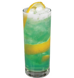A tall glass filled with a green iced drink garnished with a long lemon twist on a plain white background
