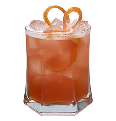 Rocks glass with orange pink iced drink orange peel loops plain background