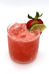 Rocks glass with red drink strawberry slice lime wheel plain background