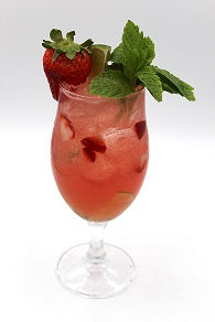 Goblet glass with pink drink strawberry mint sprig plain background