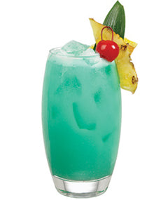 A glass filled with a turquoise iced drink garnished with pineapple and a cherry on a plain white background