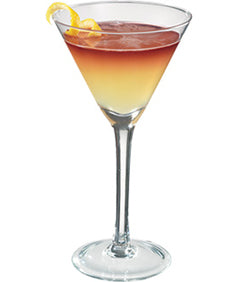 A layered cocktail with a pale yellow base and red top is served in a martini glass and garnished with lemon slices on the rim