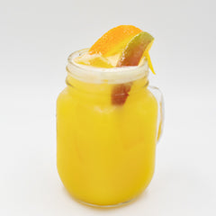 Alt text Yellow mango cocktail with orange and lime garnish in a mason jar Image description A bright yellow mango cocktail is served in a mason jar and garnished with orange and lime slices on top.