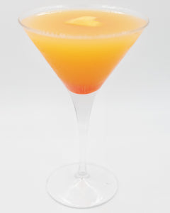 A bright orange cocktail with a darker red layer at the bottom is served in a martini glass and topped with a small lemon garnish.