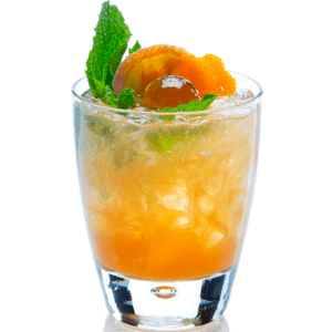 A bright orange cocktail with crushed ice is served in a short glass and garnished with fresh mint leaves and orange slices on top.
