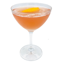 Coupe glass with orange drink orange peel plain background