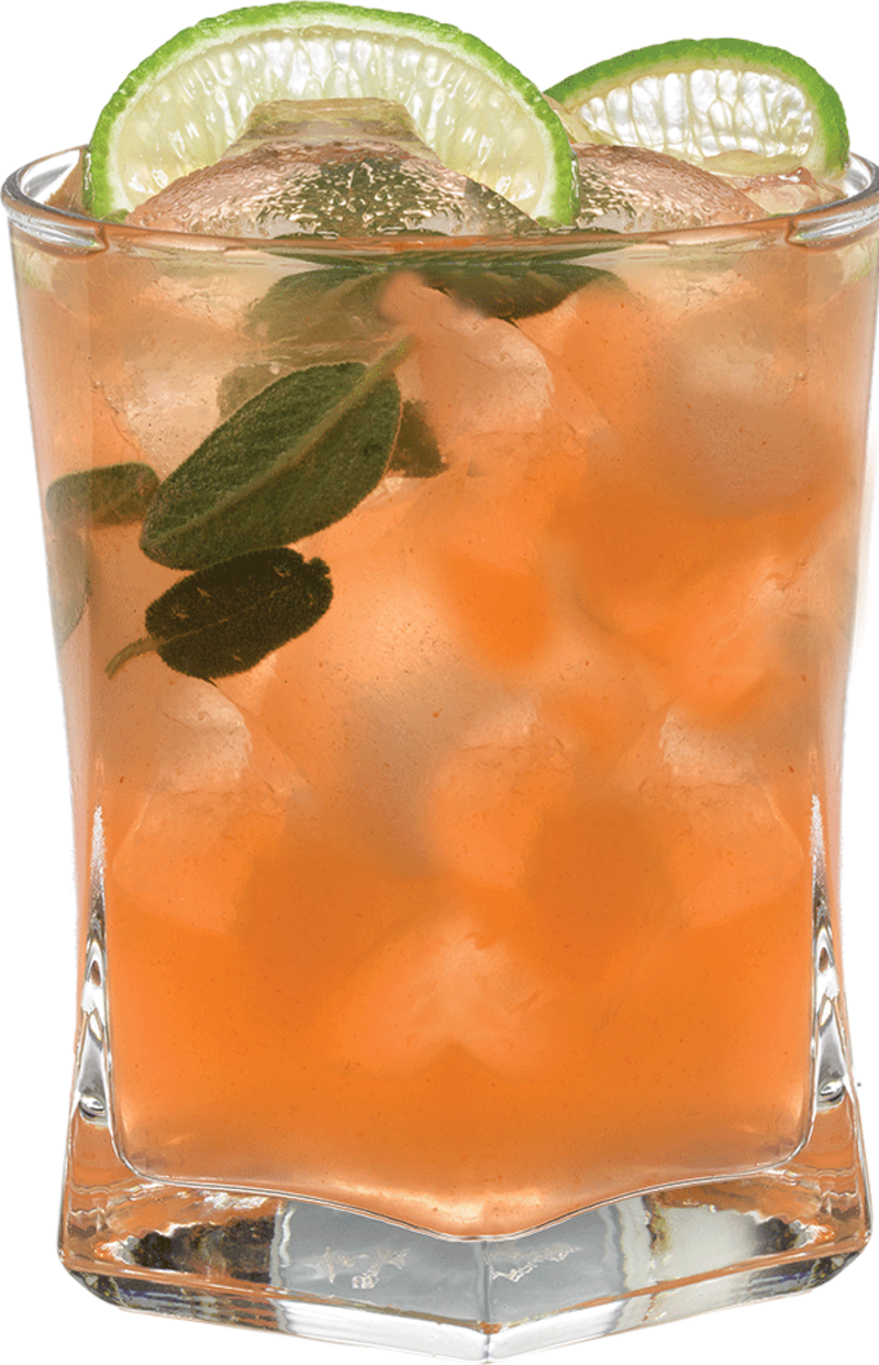 A pale peach-colored cocktail with ice is served in a short glass with fresh mint leaves inside and two lime slices on the rim.