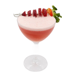 A pink cocktail with a thick white foamy top is served in a coupe glass and garnished with sliced strawberries and a whole strawberry with green leaves on top.