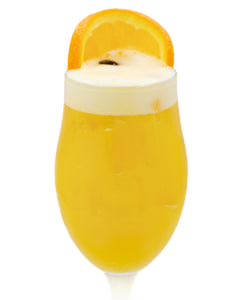 A bright yellow cocktail with a thick white foamy top is served in a tall stemmed glass and garnished with a large orange slice on the rim.