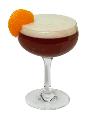 A dark red cocktail is served in a coupe glass with a thick layer of white foam and garnished with an orange slice on the rim.