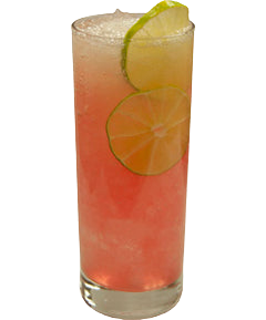 A pink cocktail with ice is served in a tall glass with lime and orange slices visible inside and a lime wedge on the rim.