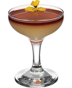 A layered cocktail with a pale yellow base and dark red top is served in a coupe glass and garnished with a small yellow flower