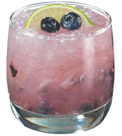 Pink blueberry cocktail with crushed ice and lime garnish in a short glass