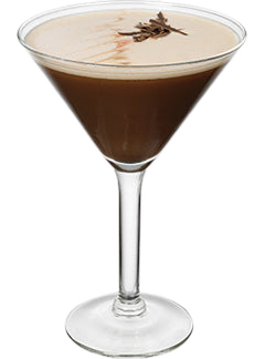 Cocktail glass with dark brown drink foam layer chocolate shavings plain background