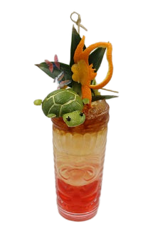 Tiki glass with layered drink lime turtle orange peel chameleon pineapple leaves plain background