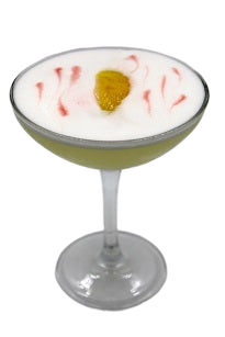 Coupe glass with yellow drink lemon peel foam swirls plain background