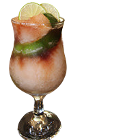 Hurricane glass with layered slush drink lime wheels bar background