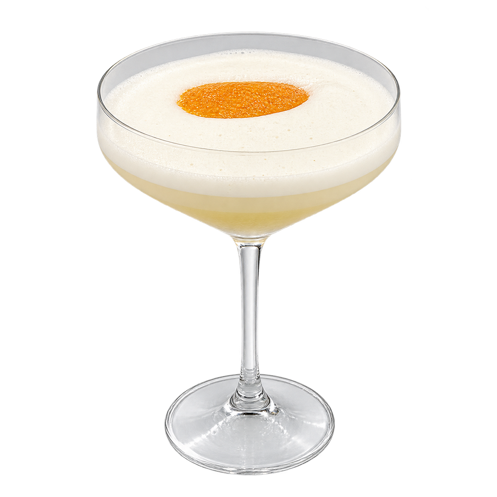 A coupe glass filled with a light-colored drink topped with thick white foam and an orange garnish on a plain background